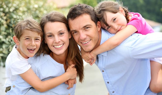 Portrait of happy family with young kids